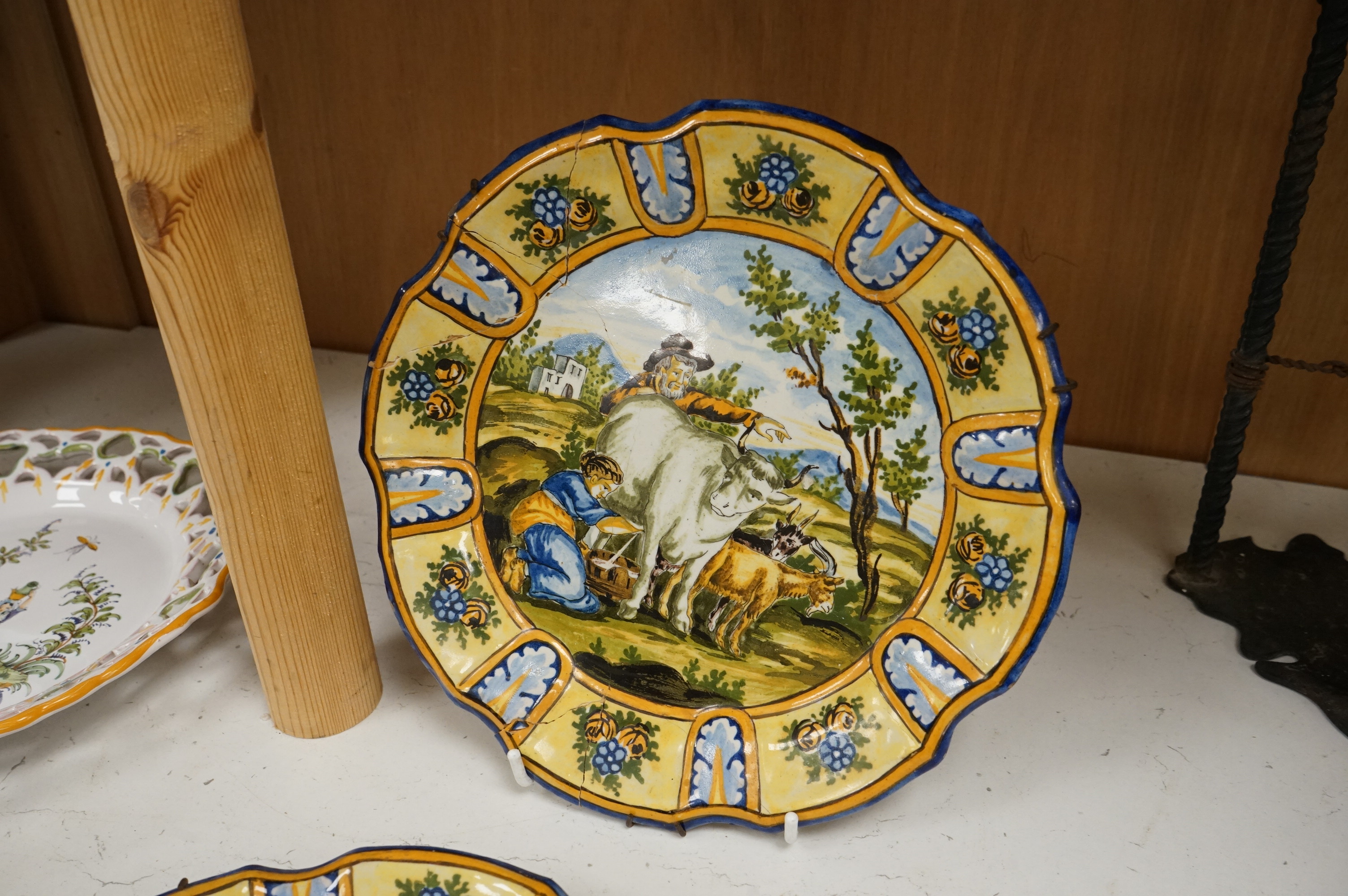A Delft charger after Artz, together with other faience and majolica dishes, largest 41cm diameter (6)